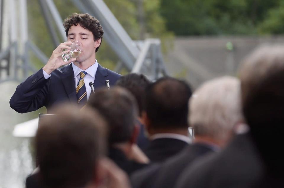 Prime Minister Justin Trudeau, left, drinks after giving a toast to Mexican President Enrique Pena Nieto at a dinner at Casa Loma in Toronto on Monday, June 27, 2016. THE CANADIAN PRESS/Nathan Denette