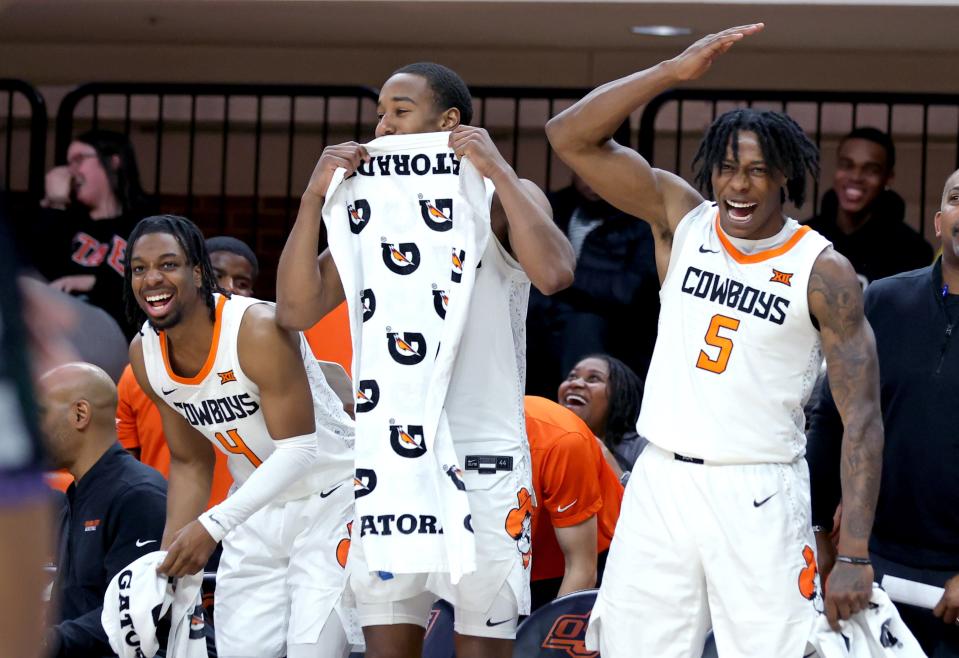 Oklahoma State's Jarius Hicklen (4), Bryce Thompson (1) and Quion Williams (5) celebrates from the bench in the second half of the college basketball game between the Oklahoma State Cowboys and the Chicago State Cougars at Gallagher-Iba Arena in Stillwater, Okla., Wednesday, Jan. 3, 2024.