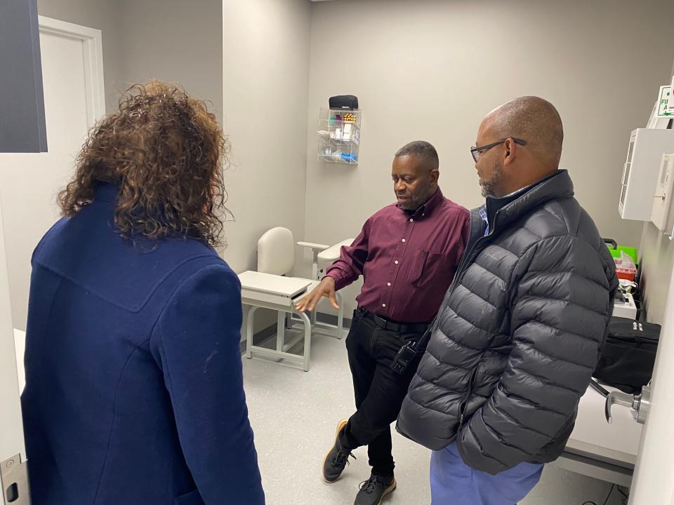 Ken Gregory, center, Columbia Public Schools security director, visits Tuesday in one of the exam rooms of the new Clarity Healthcare Scholar Clinic at its dedication. The clinic is a partnership with CPS to benefit students.