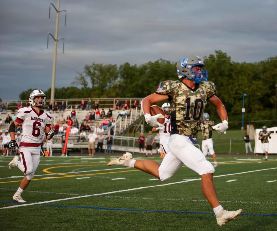 Cedar Crest receiver Nolan Groff streaks down the sideline on his way to a touchdown as Gettysburg's Daniel Spangler trails during a Week 2 game on Friday, Sept. 3, 2021. Cedar Crest defeated Gettysburg, 52-14.