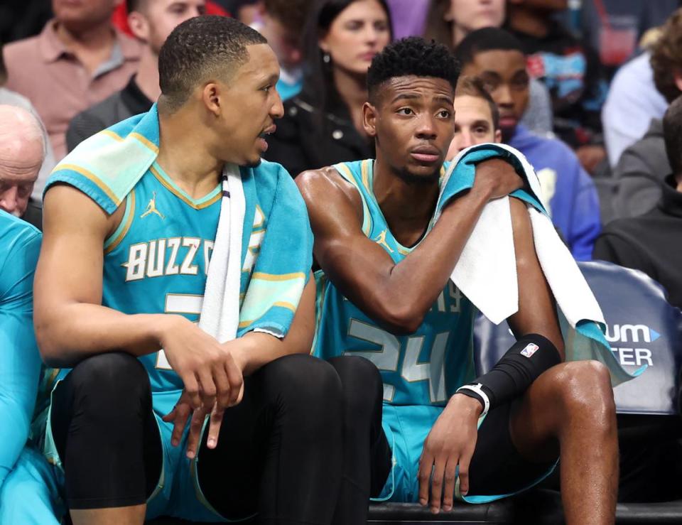 Charlotte Hornets forward Grant Williams, left, talks to forward/guard Brandon Miller, right, on the bench during first-half action against the Dallas Mavericks at Spectrum Center in Charlotte, NC on Tuesday, April 9, 2024. The Mavericks defeated the Hornets 130-104.