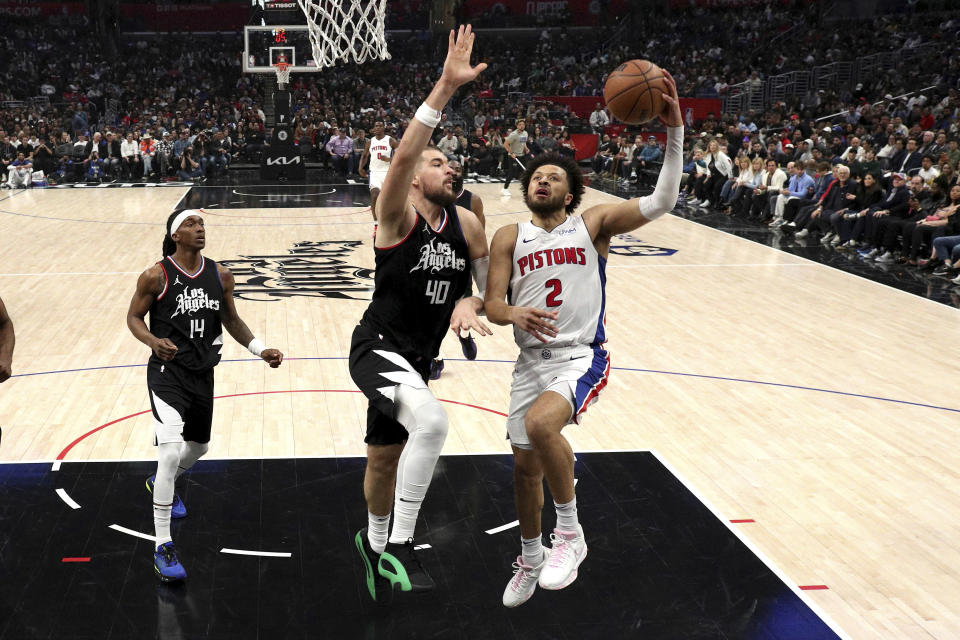 Detroit Pistons guard Cade Cunningham (2) attempts a layup past Los Angeles Clippers center Ivica Zubac (40) as guard Terance Mann (14) looks on during the first half of an NBA basketball game Saturday, Feb. 10, 2024, in Los Angeles. Clippers won 112-106. (AP Photo/Raul Romero Jr.)