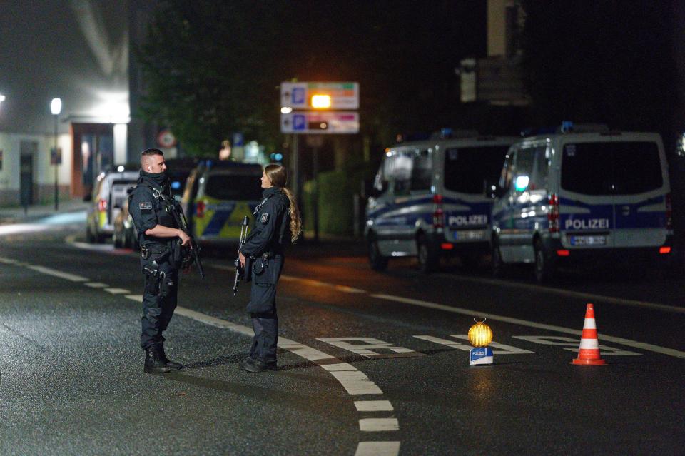 Police officers block a street in the city center during a police operation protecting the Jewish Community building in Hagen, Germany, Thursday, Sept. 16, 2021. Numerous police officers were involved in the operation, the police spoke of indications of a possible dangerous situation. (Henning Kaiser/dpa via AP)
