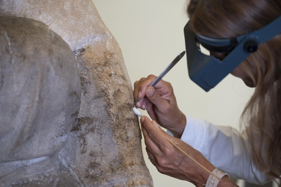 A restorer works on one of Michelangelo's Pieta sculpture in Florence, Italy, Tuesday, Sept. 8, 2020. A restoration of one of Michelangelo’s Pieta sculptures has uncovered previously unknown details, including the artist’s tool marks, that had been hidden under centuries of dust and wax. Florence’s Museo dell’Opera del Duomo said Wednesday, Sept. 16, 2020 that the cleaning of the Bandini Pieta, which began last year but was suspended because of the coronavirus pandemic, had resumed and that the public was now invited to watch restorers at work. Michelangelo carved the Bandini Pieta between 1547-1555, when he was nearly 80. (Claudio Giovannini/Opera di Santa Maria del Fiore via AP)