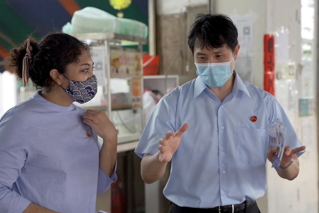 Raeesah Khan (left) and Jamus Lim, Workers’ Party candidates for Sengkang GRC, seen on walkabout in Anchorvale Link on 2 July 2020. (PHOTO: Yahoo News Singapore)