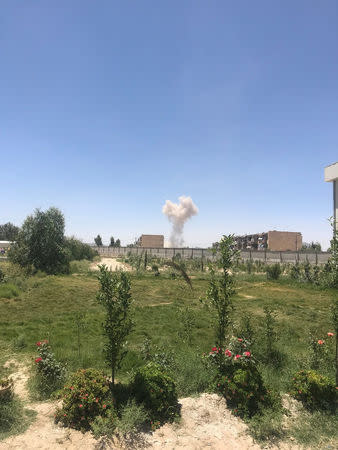 A cloud of smoke is seen after an explosion in Kandahar, Afghanistan May 22, 2018 in this picture obtained from social media. AZEEM ZMARIAL/via REUTERS
