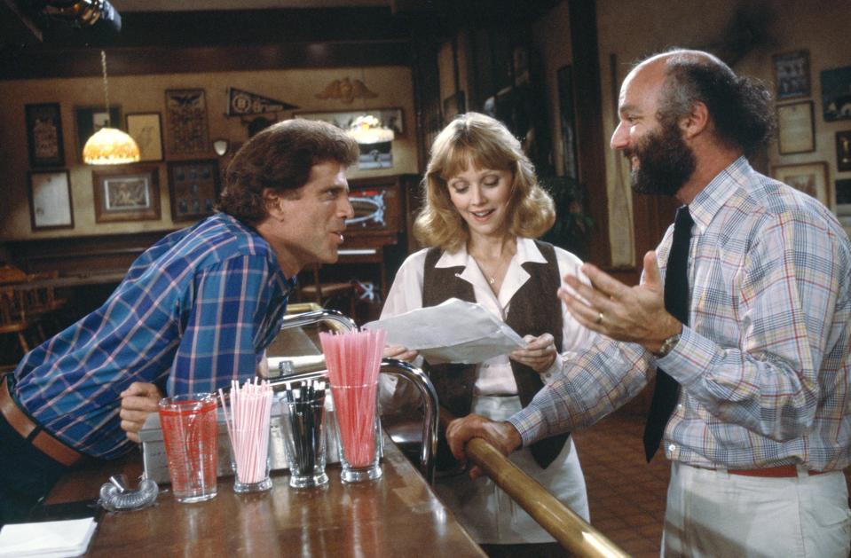 <i>Cheers</i> co-creator and director James Burrows (r) seen here going over a scene with stars Ted Danson (Sam Malone) and Shelley Long (Diane Chambers). (Photo: NBCUniversal)