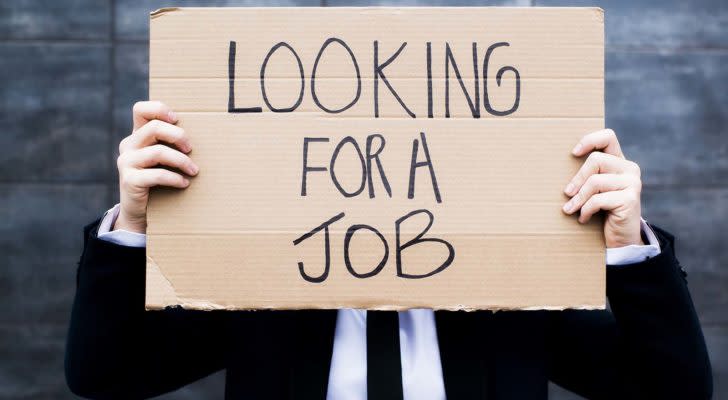 Man holding sign that reads "Looking for a job"