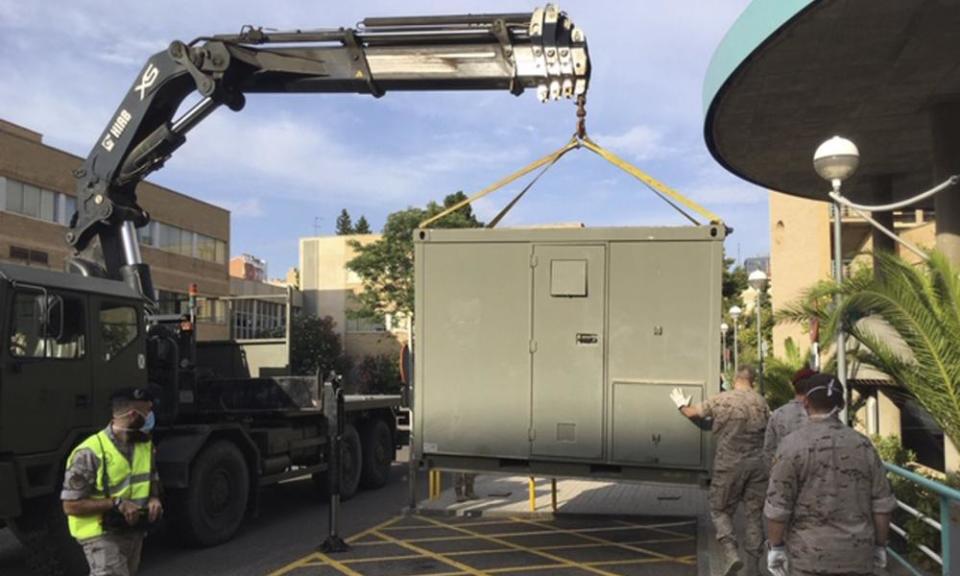 In this photo provided by the Spanish Ministry of Defence, soldiers install modules in the car park of the Hospital Clínico Universitario in Zaragoza, Spain, on Tuesday.