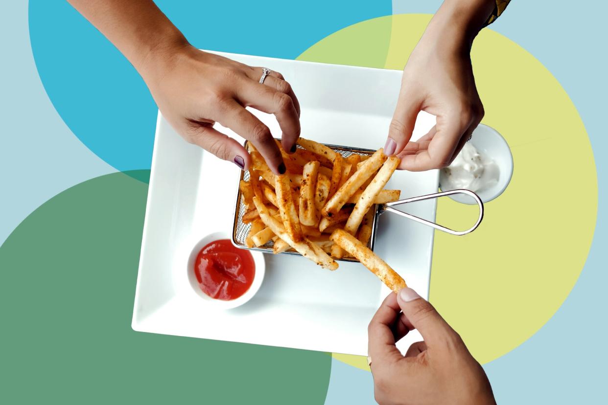 a group of people eating fries from a restaurant