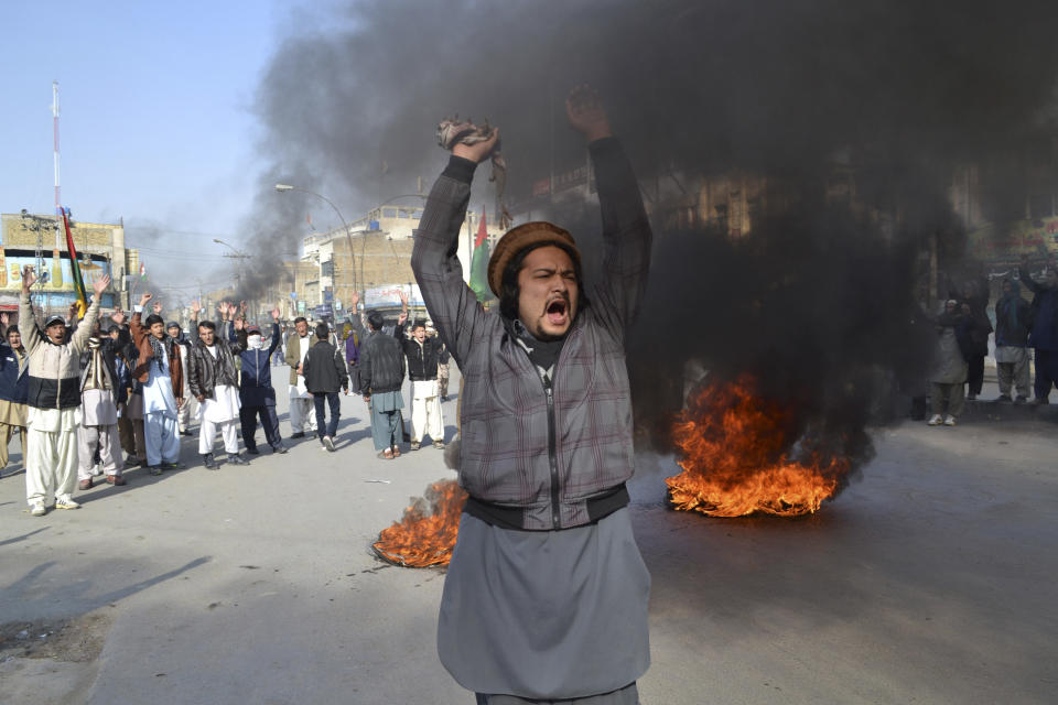 A Pakistani Muslim Shiite shouts slogans next to burning tires, during a protest in Quetta, Pakistan, Wednesday, Jan. 22, 2014. Shiite Muslims in Baluchistan protested Wednesday in Quetta, the capital of Baluchistan, demanding action to stop the continued violence against their sect; they brought the coffins of many of the dead into the streets as part of their protest. (AP Photo/Arshad Butt)