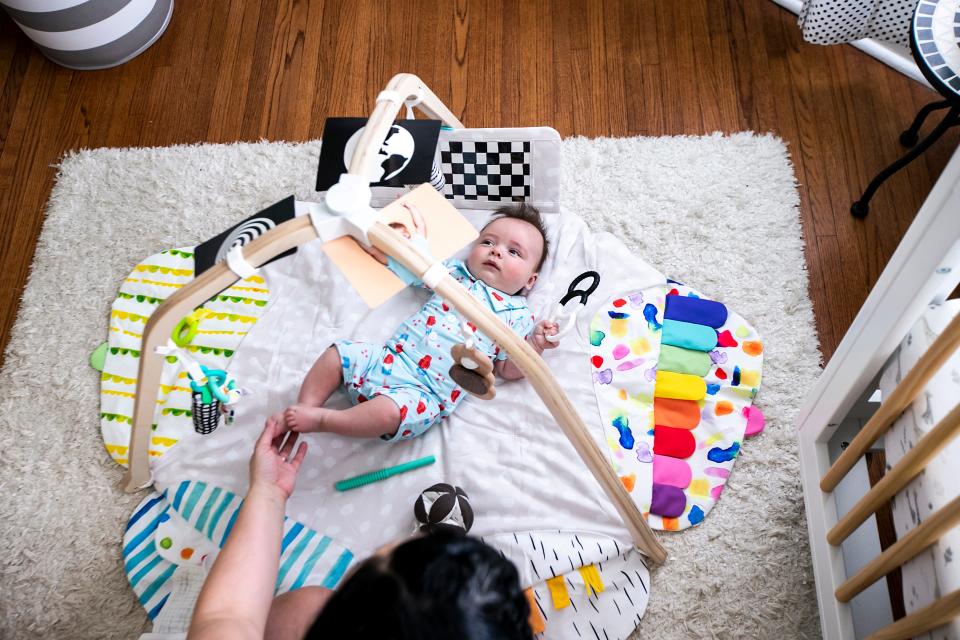 Stephanie Amundson plays with her son, Sebastian, in his nursery.