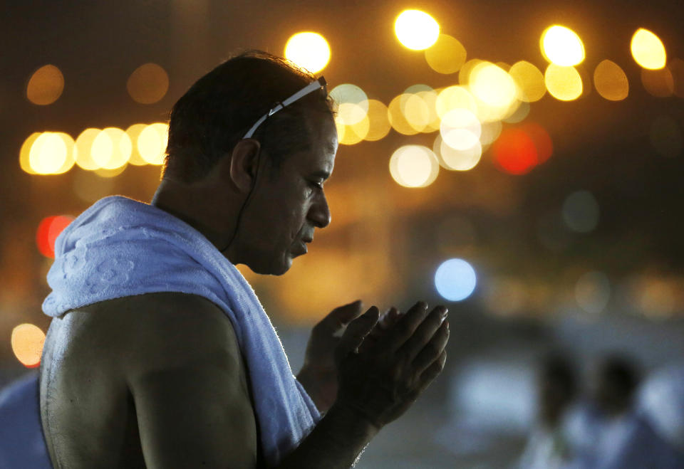 A Muslim pilgrim prays on a rocky hill known as Mountain of Mercy, on the Plain of Arafat, during the annual hajj pilgrimage, near the holy city of Mecca, Saudi Arabia, Saturday, Aug. 10, 2019. More than 2 million pilgrims were gathered to perform initial rites of the hajj, an Islamic pilgrimage that takes the faithful along a path traversed by the Prophet Muhammad some 1,400 years ago. (AP Photo/Amr Nabil)