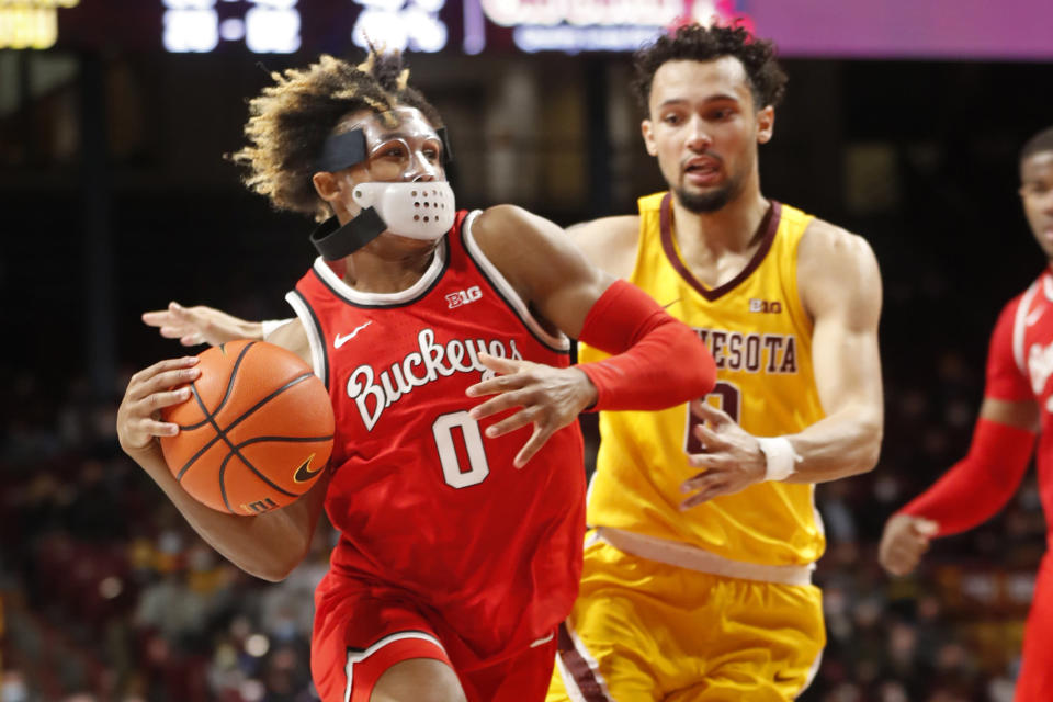 Ohio State guard Meechie Johnson Jr. (0) drives around Minnesota guard Payton Willis, right, to the basket in the second half of an NCAA college basketball game Thursday, Jan. 27, 2022, in Minneapolis. (AP Photo/Bruce Kluckhohn)