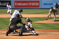 Los Angeles Dodgers' A.J. Pollock, left, hits a three-run home run as San Francisco Giants relief pitcher Tyler Rogers, right, watches along with catcher Tyler Heineman, second from right, and home plate umpire Adam Hamari during the seventh inning of a baseball game Sunday, Aug. 9, 2020, in Los Angeles. (AP Photo/Mark J. Terrill)