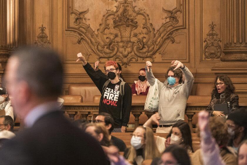 People react to public comment at the San Francisco Board of Supervisors meeting in San Francisco, Monday, Jan. 8, 2024. The city's board of supervisors is taking up a controversial resolution calling for a sustained cease-fire in Gaza, a resolution that pro-Palestinian and Jewish peace groups have successfully pushed through in other cities. (AP Photo/Nic Coury)