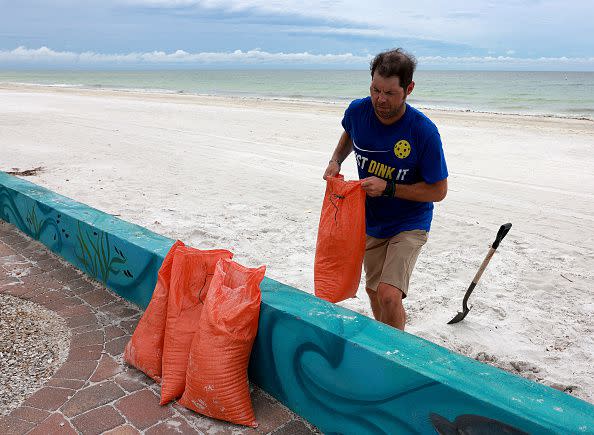ST. PETERSBURG BEACH, FLORIDA - SEPTEMBER 27: Mark Johnstone fills sandbags as he prepares for the possible arrival of Hurricane Ian on September 27, 2022 in St Petersburg Beach, Florida. Hurricane Ian is expected to make landfall in the Tampa Bay area Wednesday night into early Thursday morning. (Photo by Joe Raedle/Getty Images)