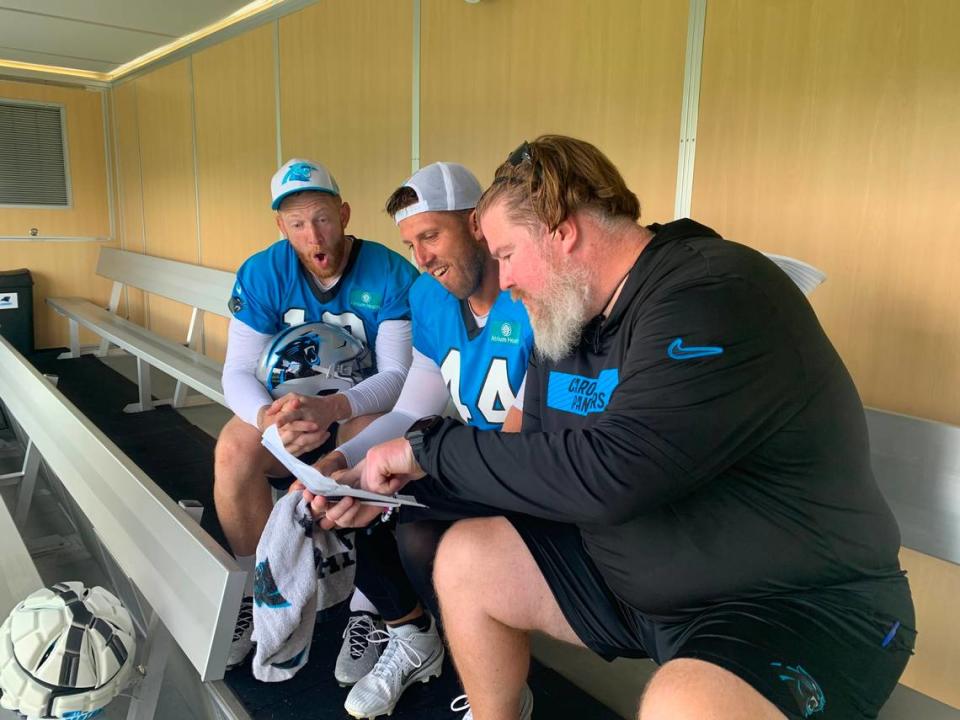 Carolina Panthers punter Johnny Hekker (left) and long snapper JJ Jansen (middle) chat with the team’s director of human performance, Andrew Althoff, inside the cooling trailer on the franchise’s practice field. Aug. 5, 2024