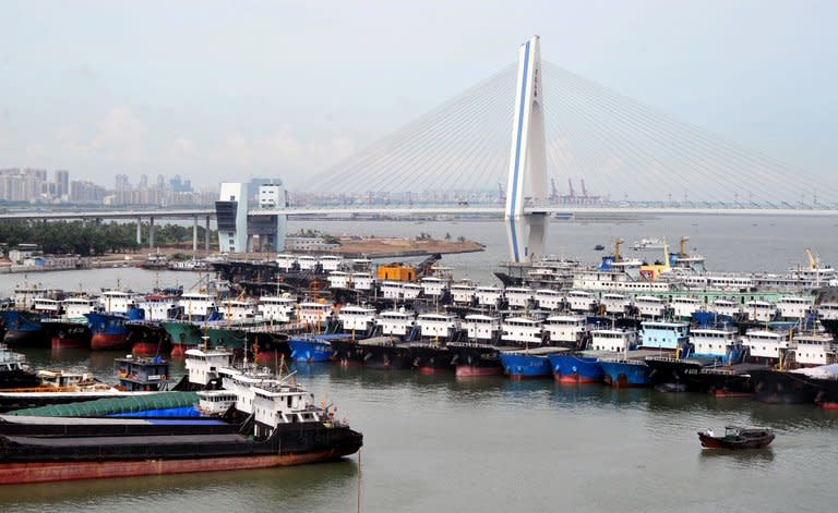 Fishing boats are berthed in a port in Haikou, China's Hainan province, as powerful Typhoon Utor approaches on August 13, 2013. Utor is predicted to make landfall on Wednesday night or Thursday morning, according to China's state news agency Xinhua