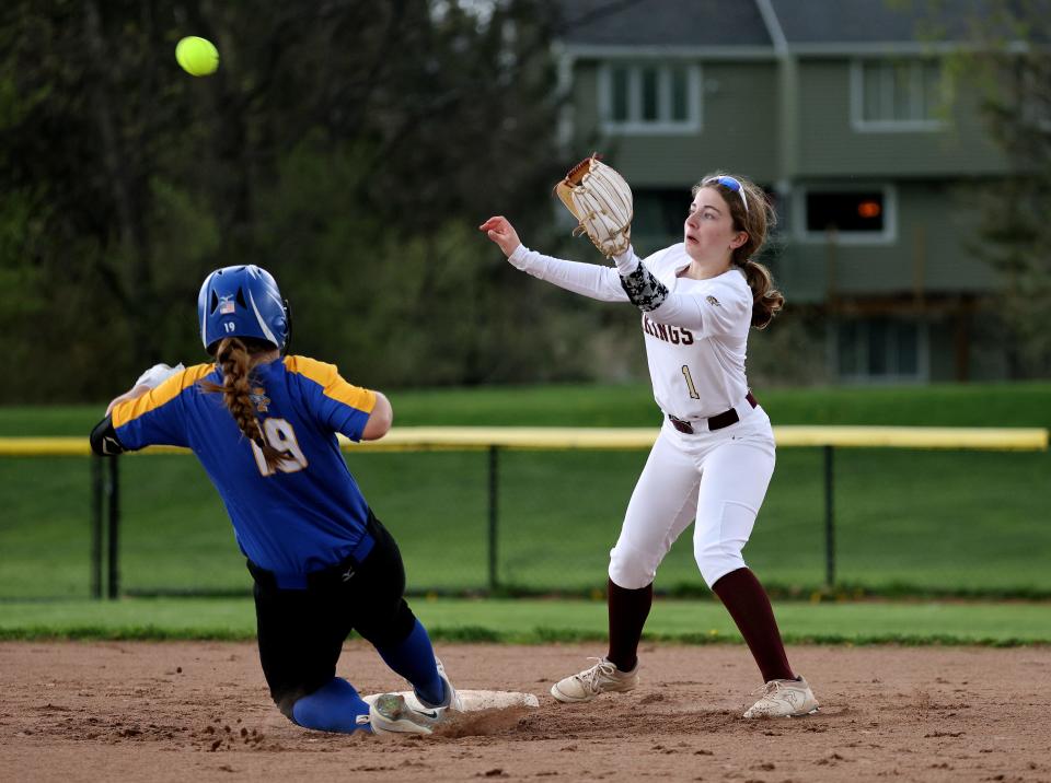 Irondequoit’s Abigail Ras beats the throw to Mendon shortstop Alexandra Van Ginhoven and steals second base. 