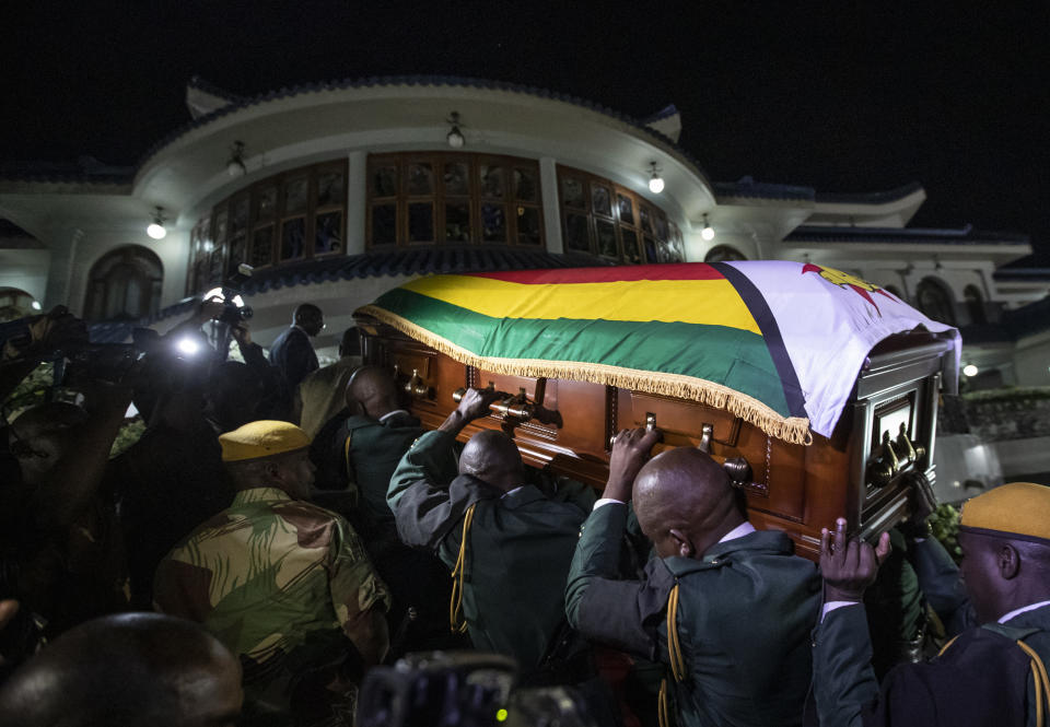 The body of former president Robert Mugabe arrives to lie in state inside his official residence in the capital Harare, Zimbabwe Wednesday, Sept. 11, 2019. Zimbabwe's founding leader Robert Mugabe made his final journey back to the country Wednesday, his body flown into the capital amid the contradictions of his long, controversial rule. (AP Photo/Ben Curtis)