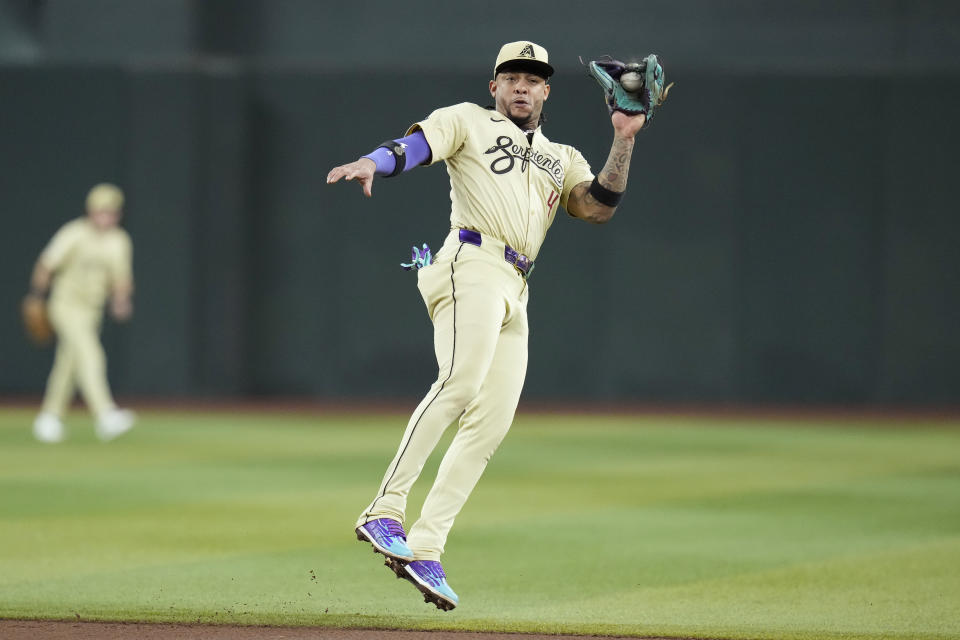 Arizona Diamondbacks second baseman Ketel Marte makes a leaping catch on a liner hit by San Francisco Giants' Patrick Bailey during the seventh inning of a baseball game Tuesday, Sept. 24, 2024, in Phoenix. (AP Photo/Ross D. Franklin)