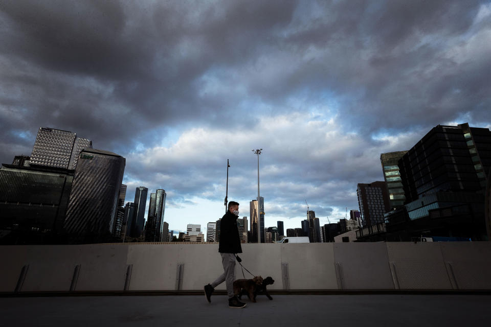 A Melbourne man walks his dog under strict Stage 4 restrictions. Source: Getty