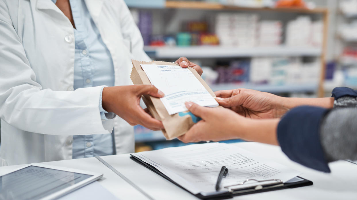 Closeup shot of an unrecognizable pharmacist assisting a customer in a chemist.