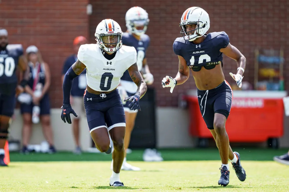 Auburn DB Keionte Scott (0) and WR Caleb Burton III (10) during a practice at the Woltosz Football Performance Center on Aug. 6.