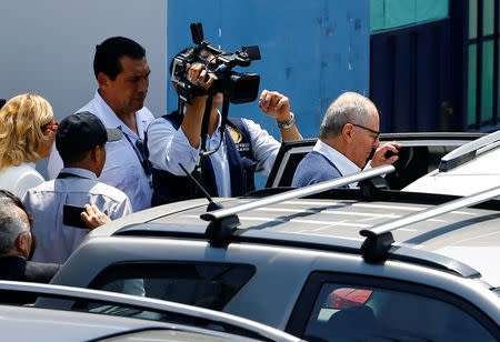 Peru's former President Pedro Pablo Kuczynski boards a car outside the Institute of Legal Medicine and Forensic Sciences, after a local judge ordered his arrest while also authorizing a search of his properties as part of a probe into a bribery scheme linked to scandal-plagued Brazilian builder Odebrecht, in Lima, Peru April 10, 2019. REUTERS/Stringer