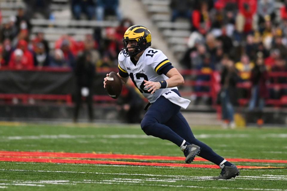 Michigan Wolverines quarterback Cade McNamara (12) rushes during the first half Nov. 20, 2021 against the Maryland Terrapins at Capital One Field at Maryland Stadium.