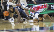 Butler guard Bo Hodges (1) and Villanova forward Jermaine Samuels (23) dive on a loose ball during the first half of an NCAA college basketball game, Sunday, Jan. 16, 2022, in Philadelphia, Pa. (AP Photo/Laurence Kesterson)