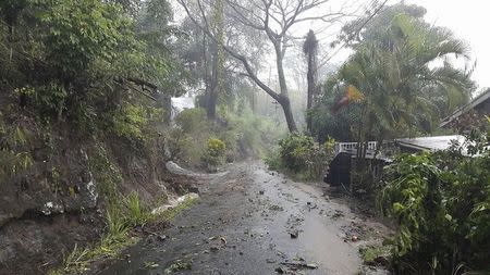 Debris covers a road after heavy rains from Tropical Storm Erika hit the Caribbean island of Dominica in this picture from Robert Tonge, Dominican Minister for Tourism and Urban Renewal, taken August 27, 2015. REUTERS/Robert Tonge, Dominican Minister for Tourism and Urban Renewal/Handout via Reuters