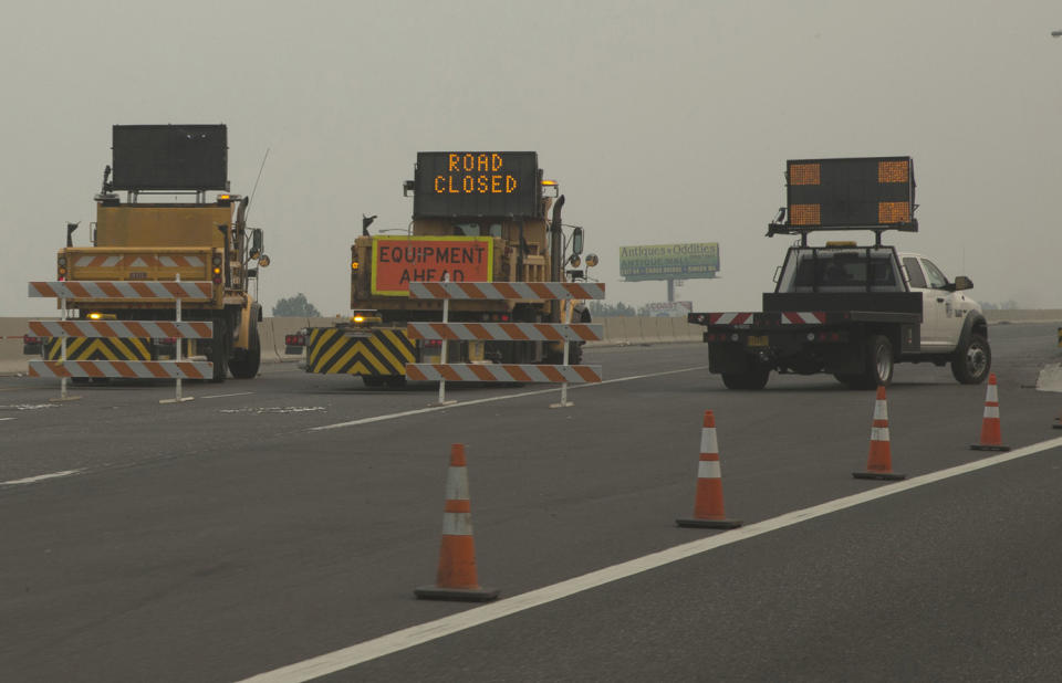 <p>Oregon Department of Transportation vehicles block Interstate 84 at Troutdale, Ore., Sept. 5, 2017 as smoke hangs in the air of a seven-square mile (18-square kilometers) fire that started Saturday. (Photo: Chris Pietsch/The Register-Guard via AP) </p>
