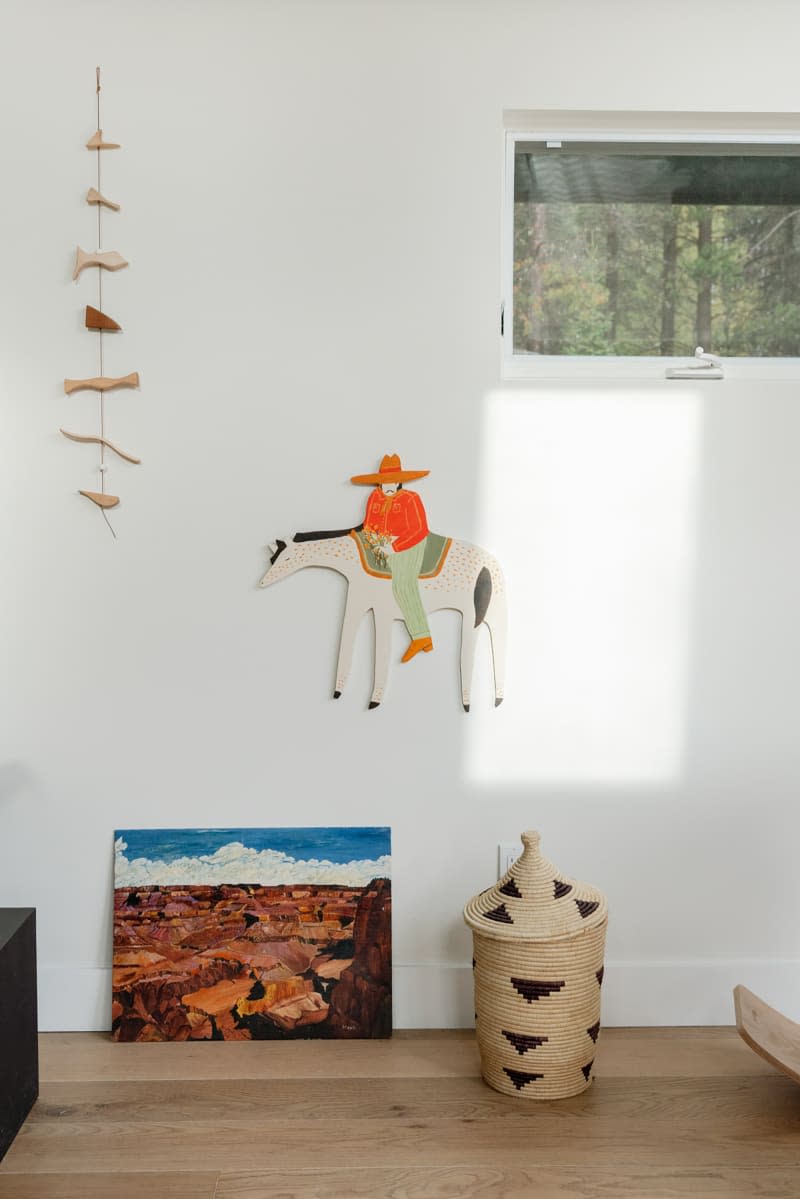 Cowboy wood carving mounted on bedroom wall.