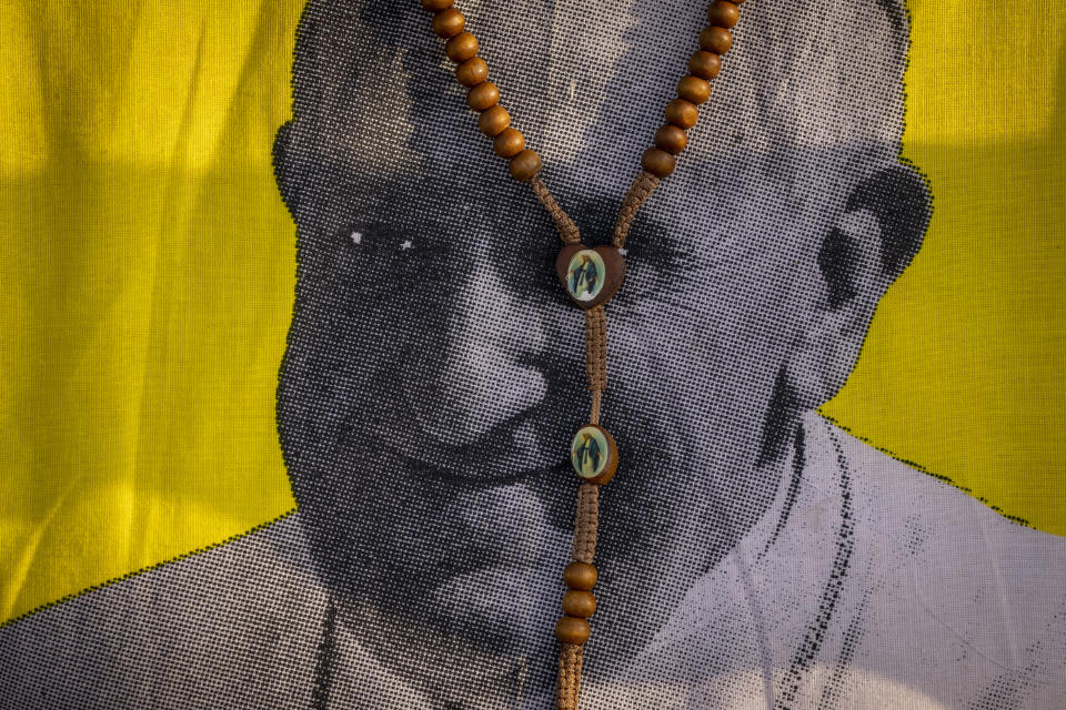 A necklace showing the Virgin Mary is seen around the neck of a woman wearing a t-shirt with a picture of Pope Francis, as she awaits his arrival at the St. Theresa Cathedral in Juba, South Sudan, Saturday, Feb. 4, 2023. Pope Francis is in South Sudan on the second leg of a six-day trip that started in Congo, hoping to bring comfort and encouragement to two countries that have been riven by poverty, conflicts and what he calls a "colonialist mentality" that has exploited Africa for centuries. (AP Photo/Ben Curtis)