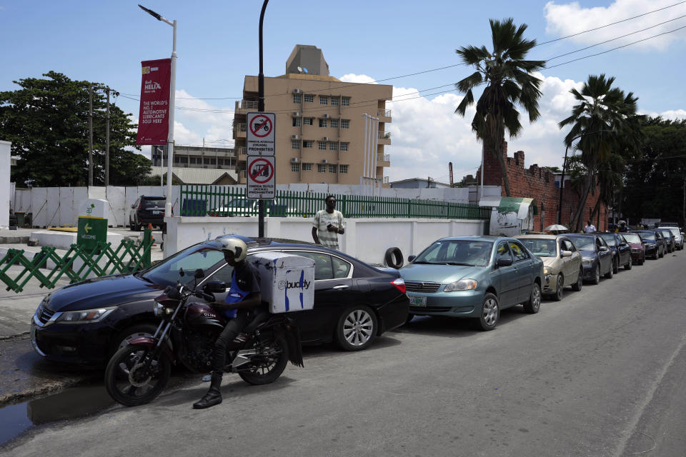 Cars queue outside a petrol station in Lagos, Nigeria, Wednesday, June. 22, 2022. (AP Photo/Sunday Alamba)