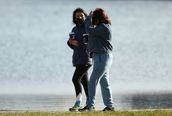 Two women walk at Albert Park Lake in Melbourne, Australia. 