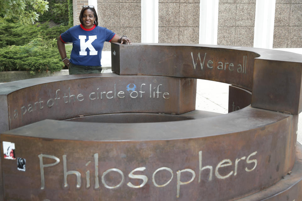 Karen Calloway, principal of Kenwood Academy in Chicago, poses Tuesday, July 28, 2020, for a portrait by the school's Inspirational Circle, designed by Kenwood students in 2003, in the Hyde Park neighborhood campus. School districts around the U.S. are working to remove police officers from campuses, but the school council for Kenwood Academy, a predominantly Black school near the University of Chicago, recently unanimously voted to keep its officer. (AP Photo/Charles Rex Arbogast)