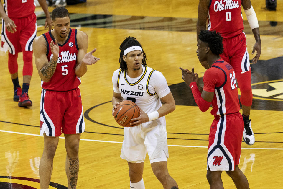 Mississippi's Jarkel Joiner, right, and KJ Buffen, left, celebrate after Missouri's Drew Buggs, center, was called for traveling during the first half of an NCAA college basketball game Tuesday, Feb. 23, 2021, in Columbia, Mo. (AP Photo/L.G. Patterson)