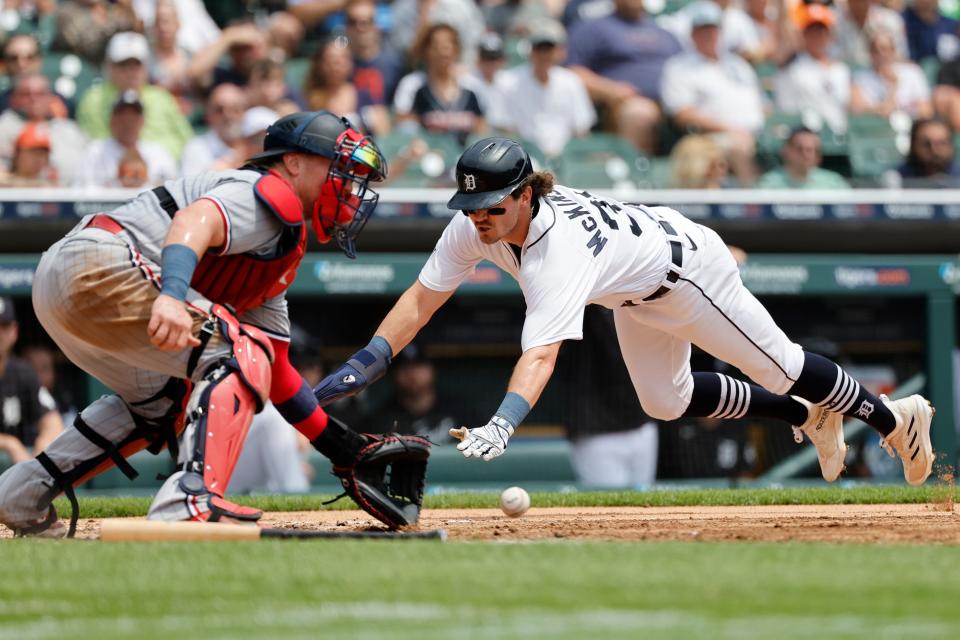 Detroit Tigers second baseman Zach McKinstry (39) dives in safe at home ahead of the throw to Minnesota Twins catcher Christian Vazquez (8) in the third inning at Comerica Park in Detroit on Sunday, June 25, 2023.