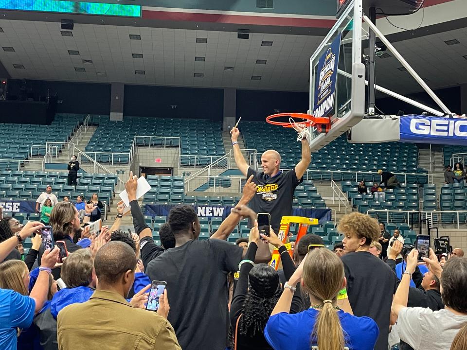 Texas A&M-Corpus Christi first-year head coach Steve Lutz cuts down the net at the Merrell Center in Katy after the Islanders beat Southeastern Louisiana 73-65 in the Southland Conference Tournament championship game on March 12, 2022.