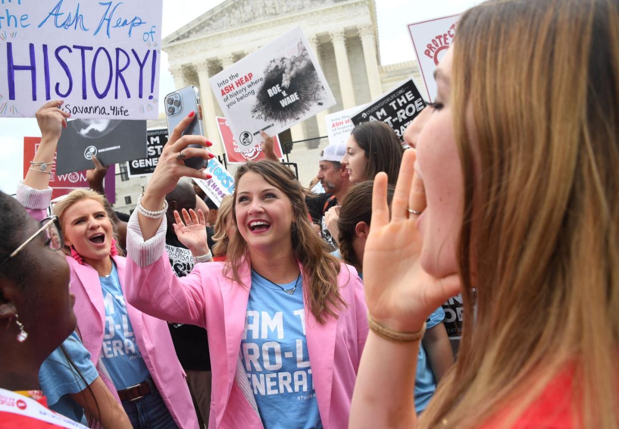 <span class="caption">Anti-abortion protestors celebrate the overturning of Roe v. Wade outside the US Supreme Court on June 24.</span> <span class="attribution"><a class="link " href="https://media.gettyimages.com/photos/antiabortion-campaigners-celebrate-outside-the-us-supreme-court-in-picture-id1241501255?s=2048x2048" rel="nofollow noopener" target="_blank" data-ylk="slk:Olivier Douliery/AFP via Getty Images;elm:context_link;itc:0;sec:content-canvas">Olivier Douliery/AFP via Getty Images </a></span>