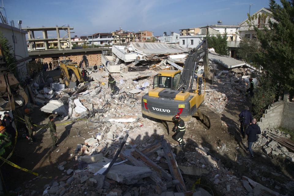 Rescuers search a damaged building in Durres, western Albania, Wednesday, Nov. 27, 2019. The death toll from a powerful earthquake in Albania has risen to 25 overnight as local and international rescue crews continue to search collapsed buildings for survivors. (AP Photo/Visar Kryeziu)