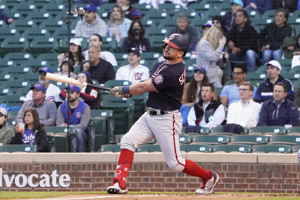 Washington Nationals' Kyle Schwarber (12) hits a two-run home run against the Chicago Cubs during the fourth inning of a baseball game, Monday, May, 17, 2021, in Chicago. (AP Photo/David Banks)