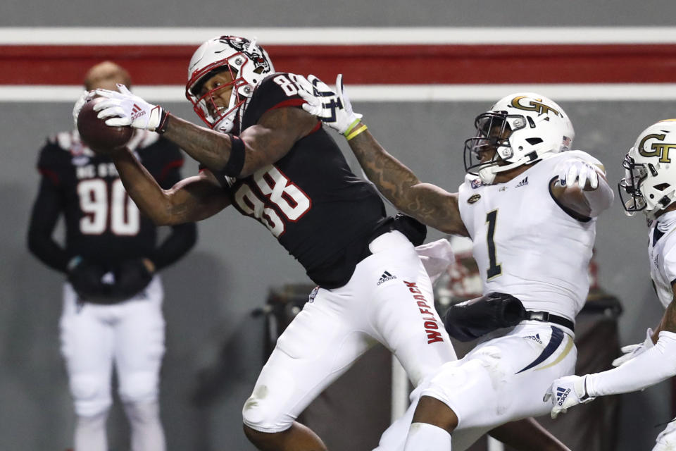 North Carolina State wide receiver Devin Carter (88) makes a reception as Georgia Tech defensive back Juanyeh Thomas (1) defends during the first half of an NCAA college football game in Raleigh, N.C., Saturday, Dec. 5, 2020. (Ethan Hyman/The News & Observer via AP, Pool)