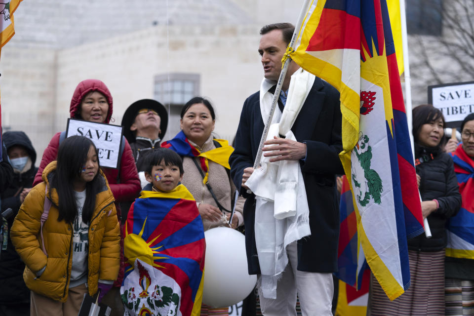 Rep. Mike Gallagher, R-Wis., holding a Tibetan flag during a rally to commemorate the failed 1959 Tibetan uprising against China's rule, outside of the Chinese Embassy in Washington, Friday, March 10, 2023. The gathering took place on what is known as Tibetan National Uprising Day and comes as tensions between the U.S. and China continue to escalate. (AP Photo/Jose Luis Magana)