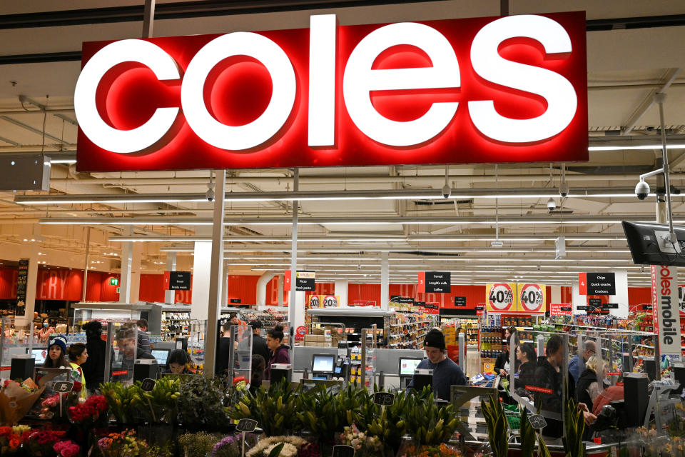 Customers separated by protective plexiglass shields are seen in the self-service checkout area of a Coles supermarket following the easing of restrictions implemented to curb the spread of the coronavirus disease (COVID-19) in Sydney, Australia, June 17, 2020.  REUTERS/Loren Elliott