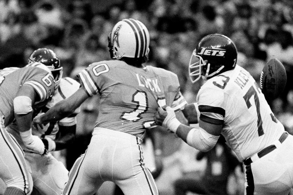 FILE - New York Jets' Joe Klecko, right, sacks Houston Oilers quarterback Oliver Luck, forcing a fumble during the first half of an exhibition NFL football game in Houston, Aug. 22, 1982. Klecko was a favorite among fans, many of whom still wear his jersey at games, and his own teammates for his big plays, vicious sacks and always standing up for his guys. (AP Photo/F. Carter Smith, File)