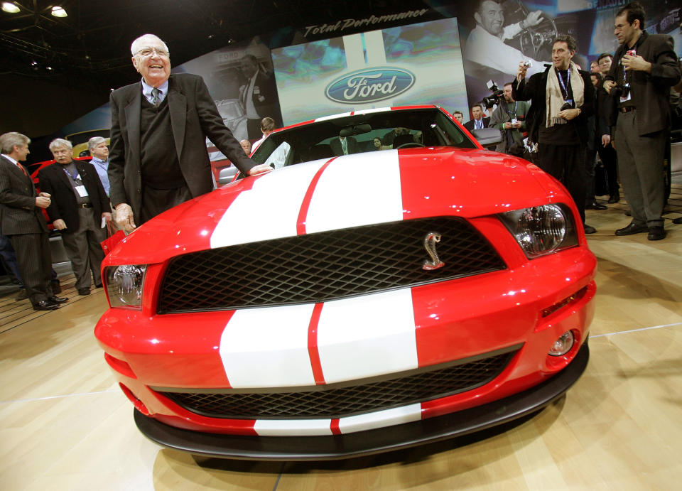 Manufacturer and automotive legend Carroll Shelby stands next to the Ford Shelby Mustang Cobra GT500 at the 2005 New York International Auto Show March 23, 2005 in New York City. The show features nearly 1,000 automobiles and continues through April 3 at the Jacob Javits Convention Center. (Photo by Mario Tama/Getty Images)